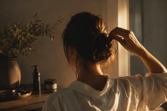 Evening image of woman letting her hair down after work.