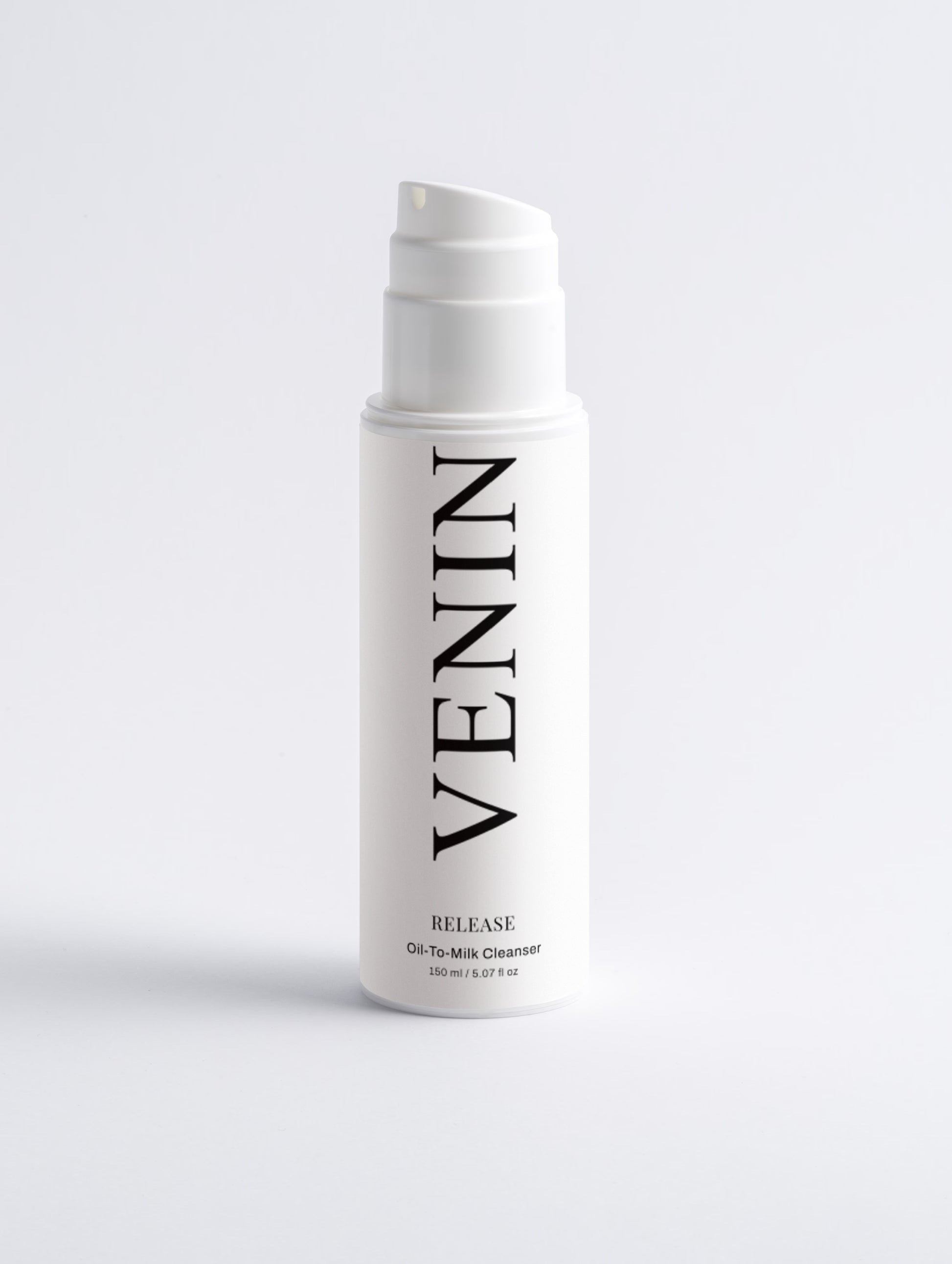 A white pump bottle of VENIN Release Oil-To-Milk Cleanser with black text, centered on a light gray background.