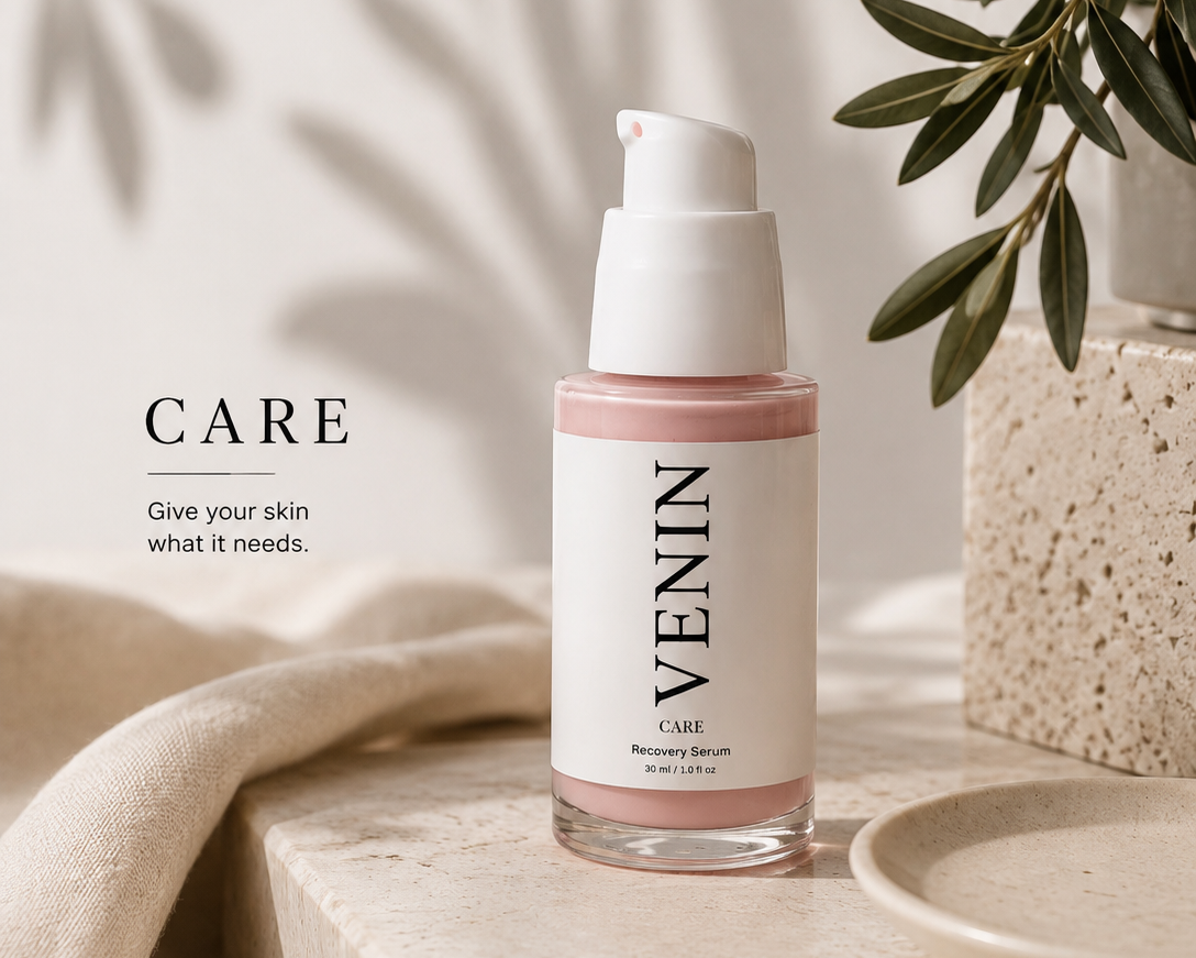 VENIN Care Recovery Serum in a clear glass bottle with a white pump, set on a beige stone surface with a beige cloth, a small dish, and olive branches in the background.